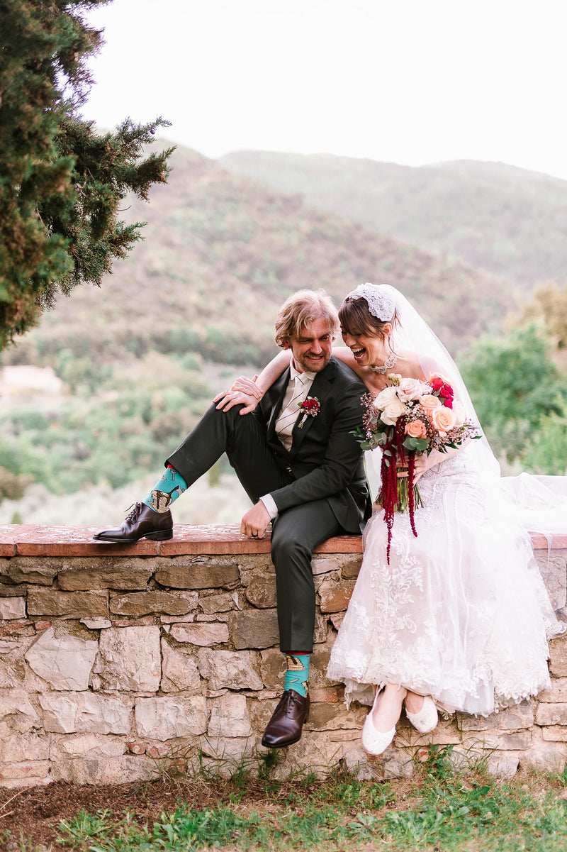 Bride wearing white bridal flats with a lace wedding dress during an outdoor wedding portrait with the groom