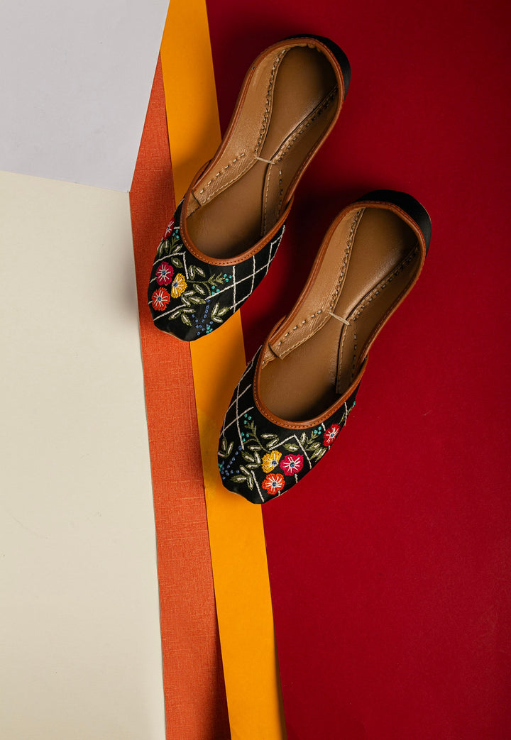 Black traditional ballerines with red, yellow and orange flower embroidery.