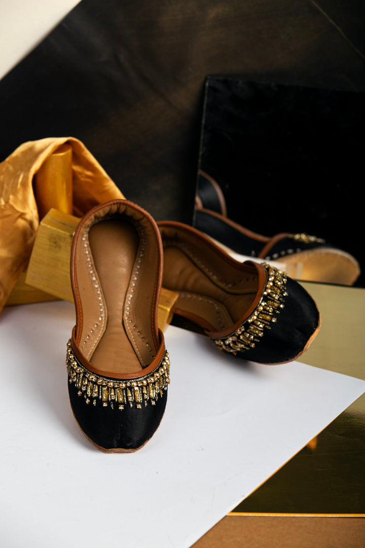 Black mojri with gold beads and gold rectangle sequins embellishments.