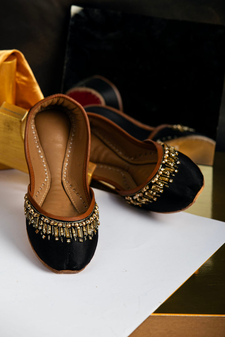 Black Indian jutti with gold beads and gold rectangle sequins embellishments.