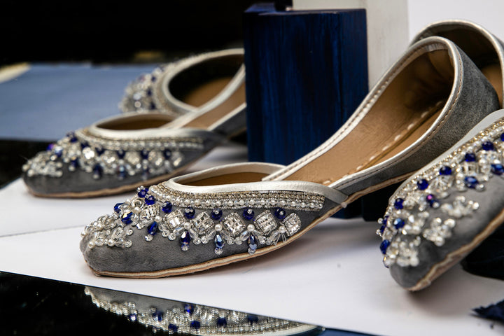 Grey Pakistani Jutti with embellishment of blue, clear and white beads and silver sequins.