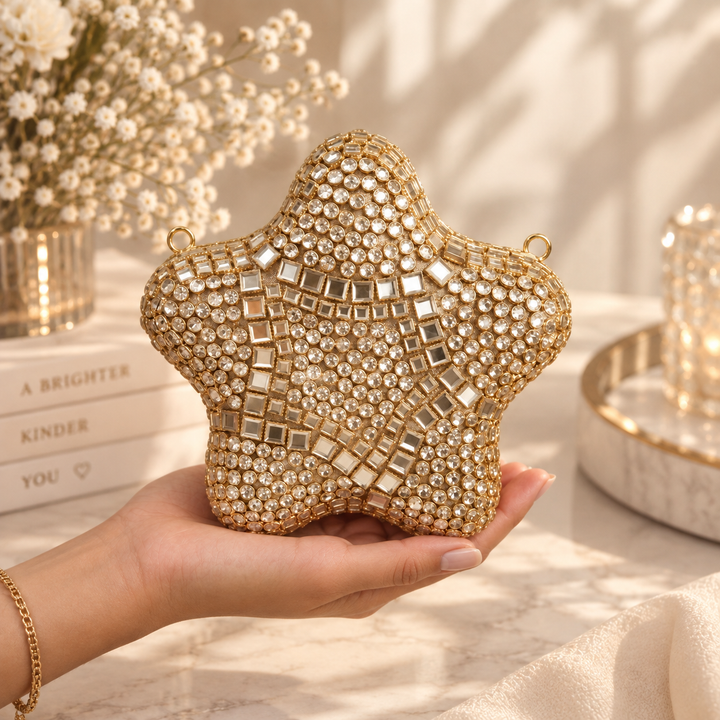 Close-up video of gold star bridal clutch showing geometric embellishments, structured shape and sparkling front details