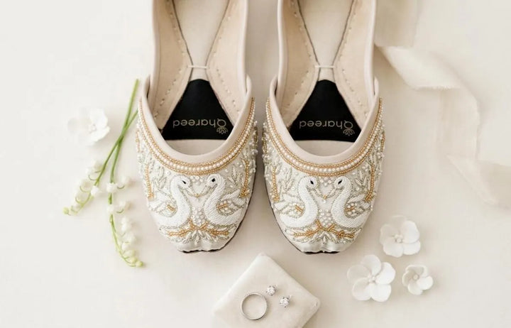 Ivory bridal flats shown from multiple angles with white swan embroidery, pearl trim and gold threadwork.